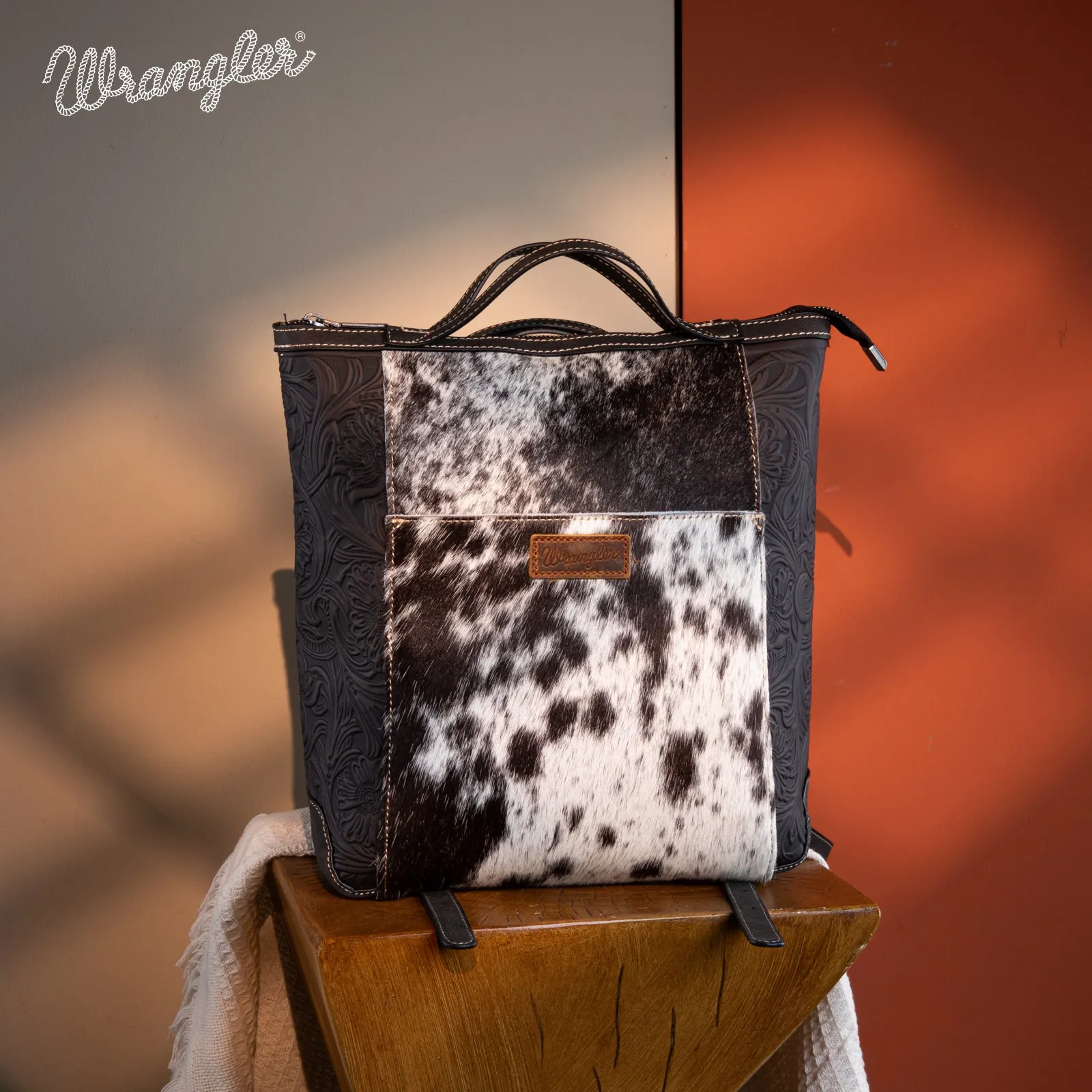 WG169-9112 Wrangler Genuine Hair-On Cowhide Floral Tooled Convertible Backpack/Crossbody - Black)